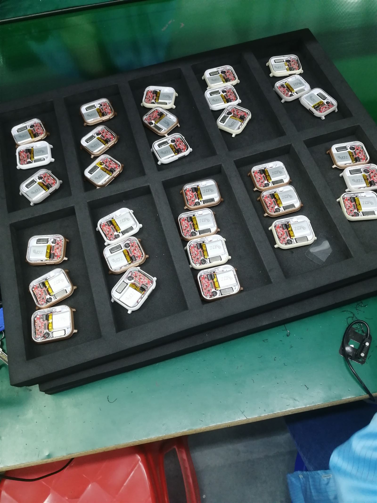 EngraSun factory — assembled watch internals with batteries