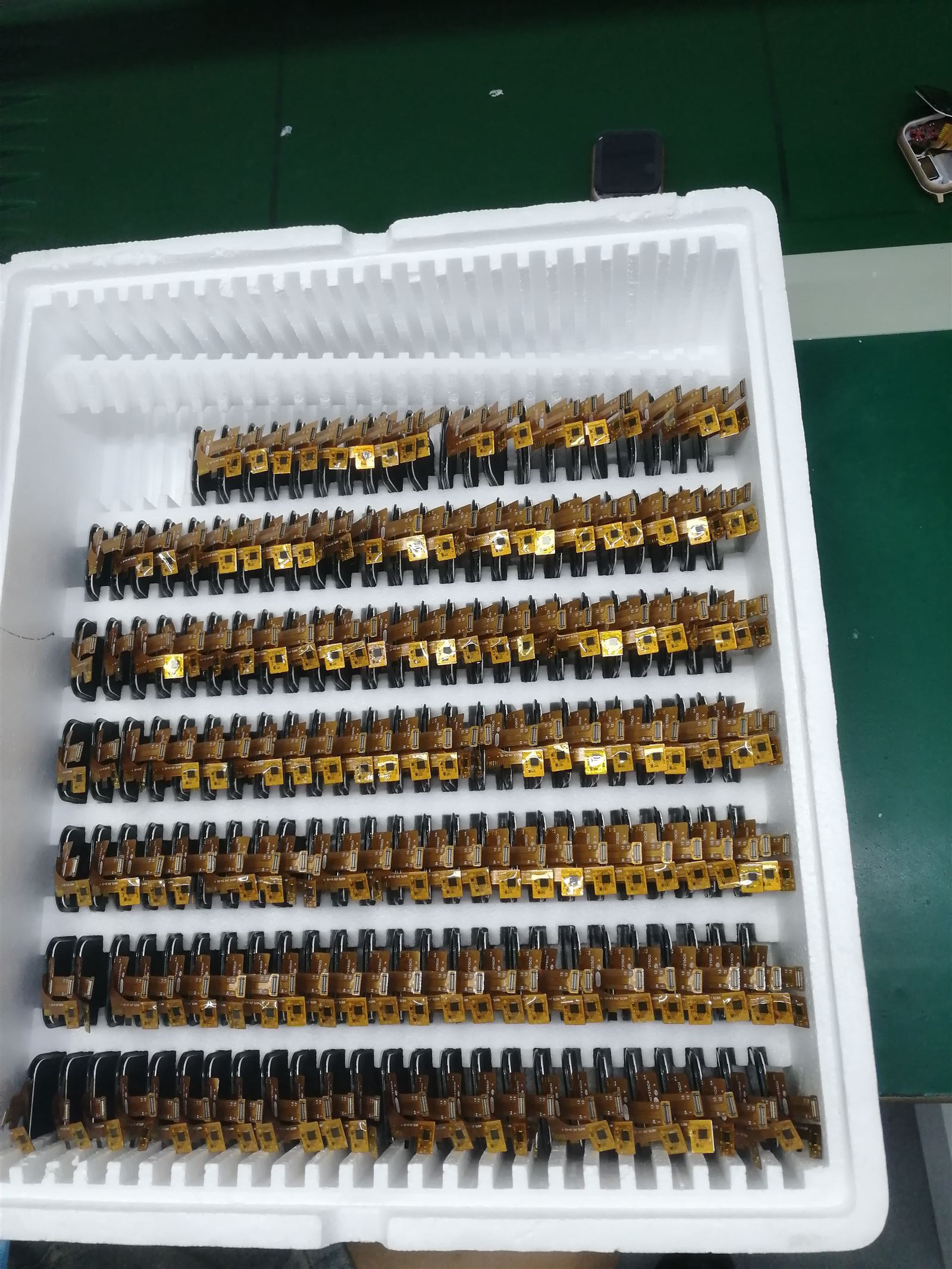 EngraSun factory — display flex-cable assemblies in foam trays