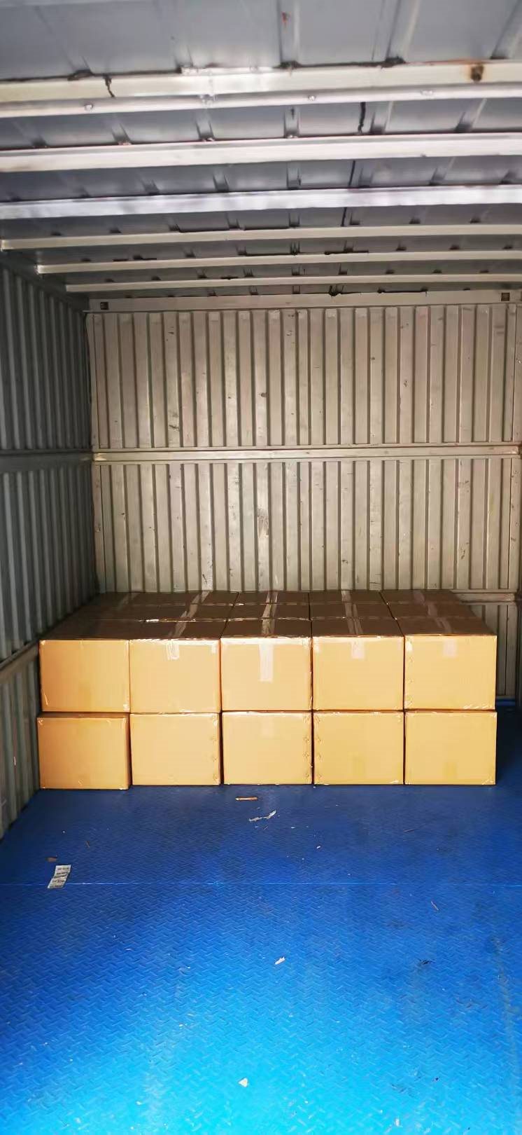 EngraSun factory — cartons loaded inside a shipping container